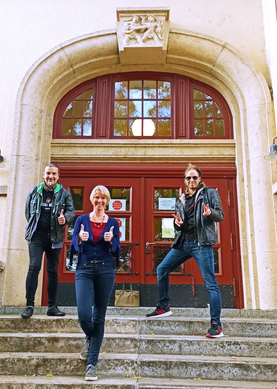 Auf diesem Bild sehen Sie die Coaches Arno, Elisabeth und Noah vor dem Eingang der Nordstadtschule.